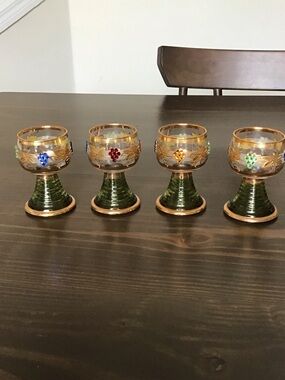 Vintage German Römer wine glasses featuring a distinct green "beehive" stem